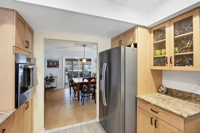 a kitchen with stainless steel appliances granite countertop a refrigerator and a stove top oven