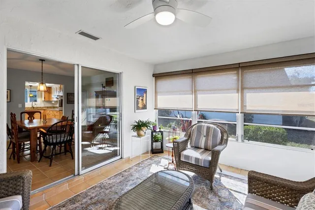 a living room with furniture and a floor to ceiling window