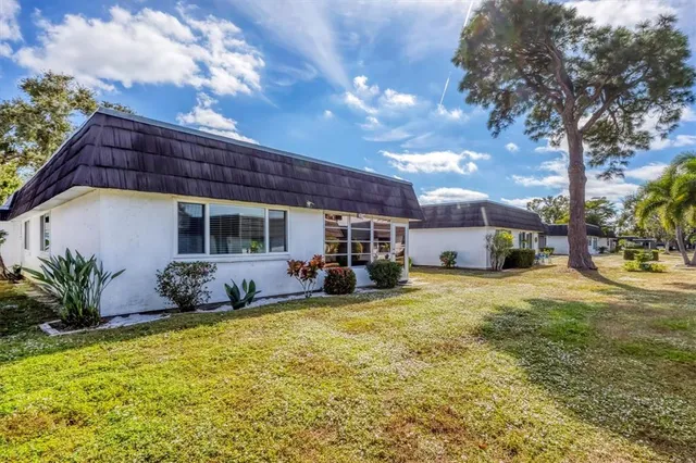 a view of a house with swimming pool and sitting area