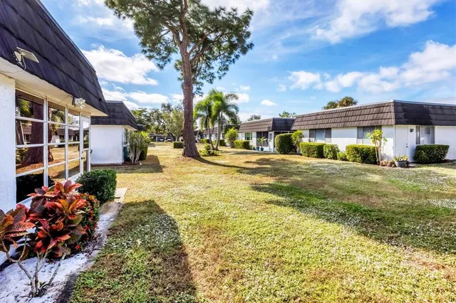 a yellow building in the middle of a yard