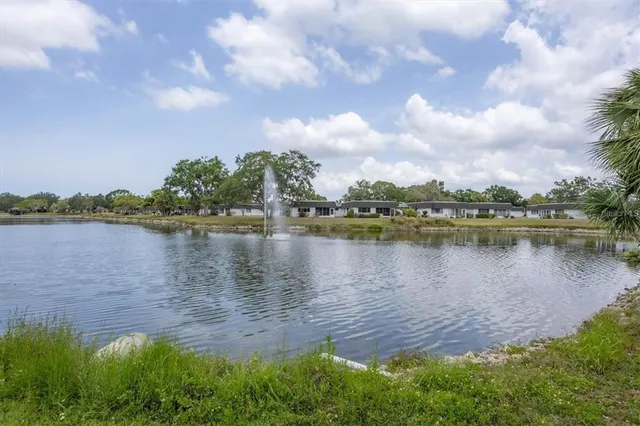a view of a lake with houses in the back