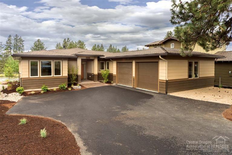 61515 Southwest Blakely Road Bend, OR 97702 - Photo 2 of 20 a front view of a house with a yard and garage