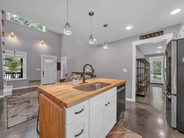 a kitchen with sink and refrigerator