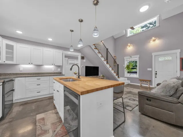 a kitchen with a stove a refrigerator and a sink