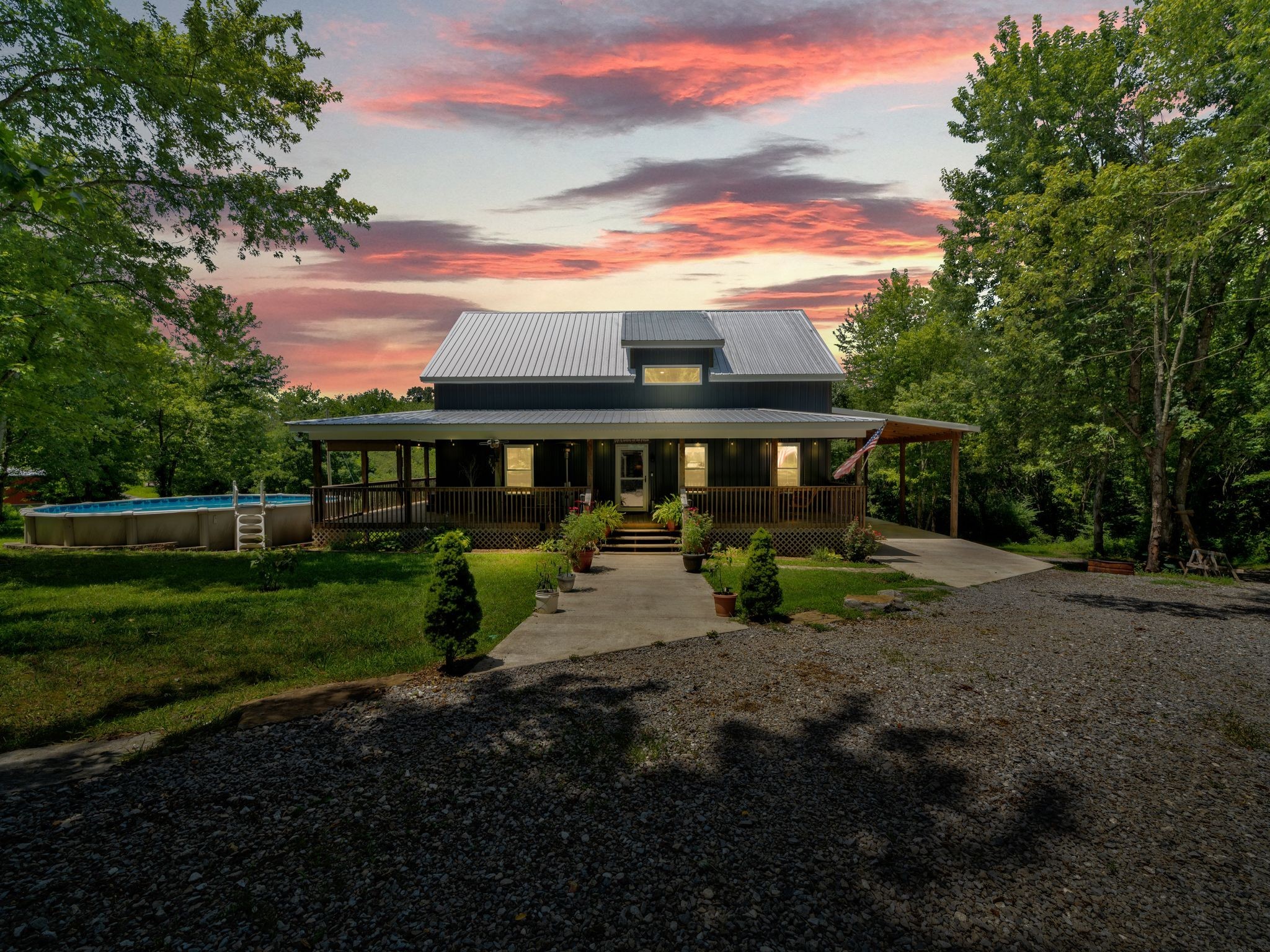 509 Iron Hill Road Burns, TN 37029 - Photo 2 of 40 a view of a house with backyard sitting area and garden