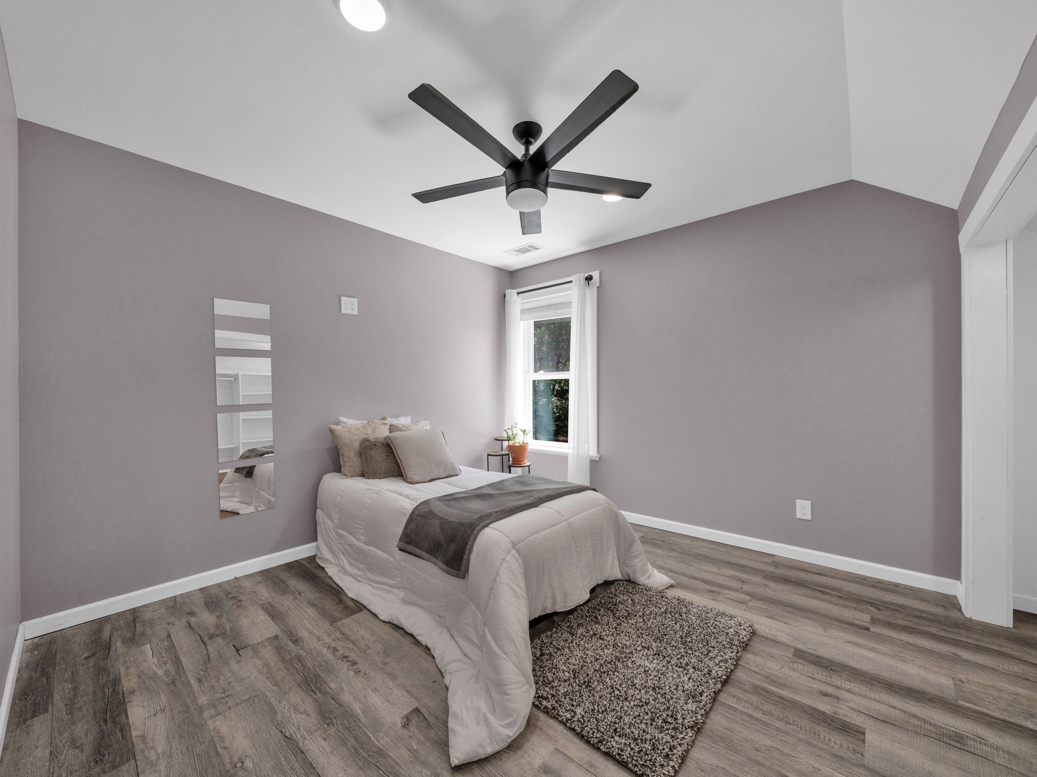 509 Iron Hill Road Burns, TN 37029 - Photo 30 of 40 a bedroom with a large bed and a ceiling fan