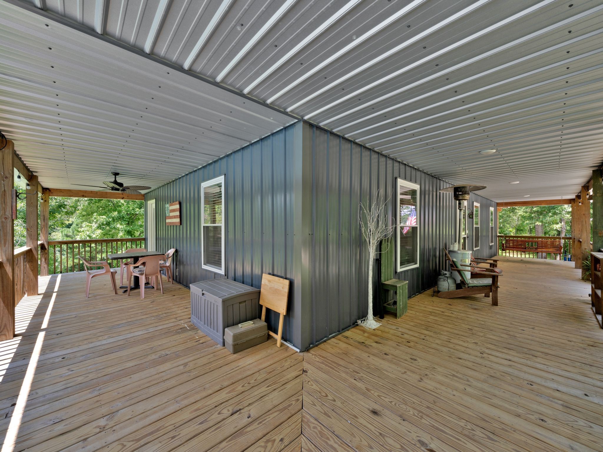 509 Iron Hill Road Burns, TN 37029 - Photo 9 of 40 a view of a patio with table and chairs and wooden floor