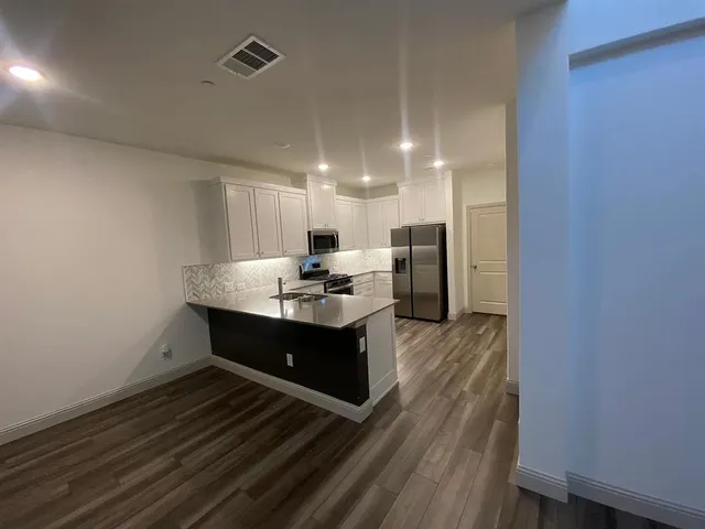 a view of kitchen with wooden floor
