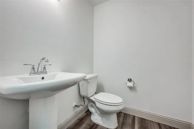 a bathroom with a sink a toilet and mirror