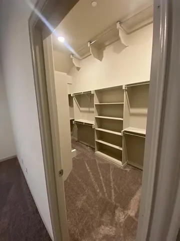 a large white bathroom with a double vanity sink a mirror and a bathtub