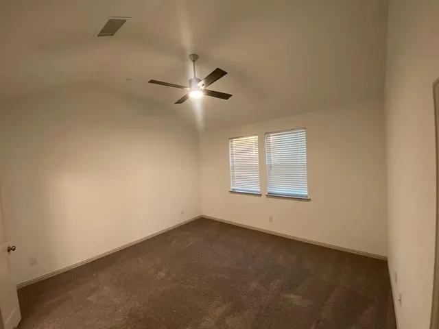 a view of house and yard with trees
