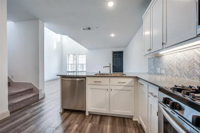 a kitchen with a sink stove and cabinets