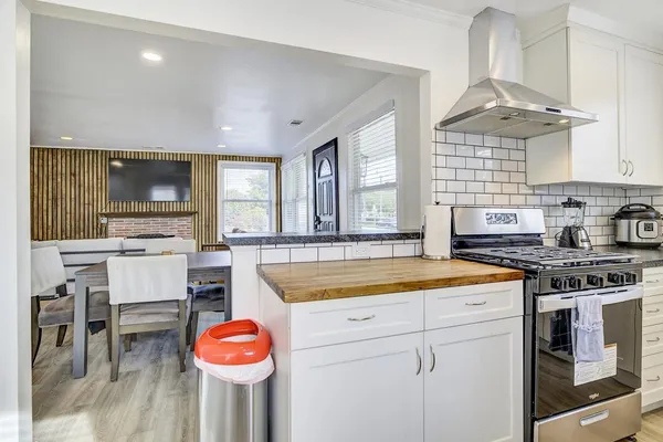a kitchen with refrigerator a microwave a sink and cabinets