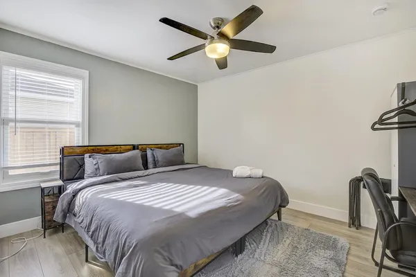 a bedroom with a bed and a window