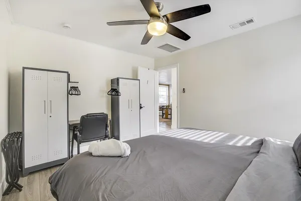 a bedroom with a bed and a mirror