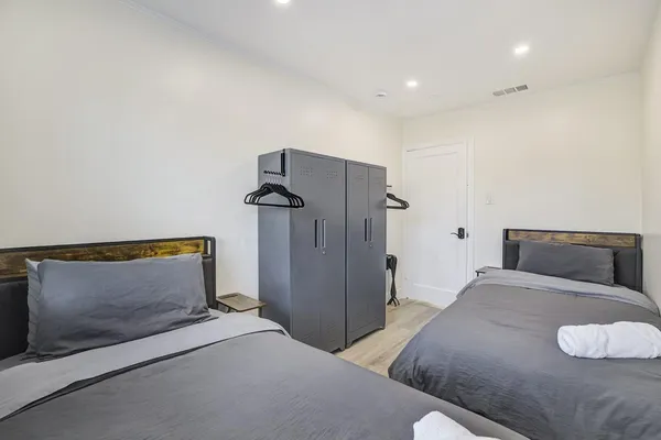 a bedroom with a bed and a lamp