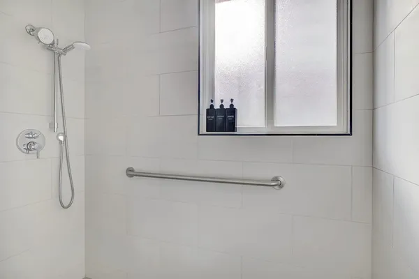 a bedroom with two beds and a lamp