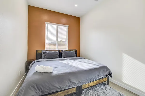 a bedroom with a bed and a table