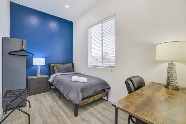 a view of a patio with table and chairs with wooden fence