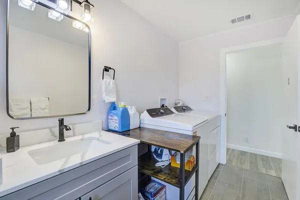 a kitchen with stainless steel appliances granite countertop a sink a stove and a microwave