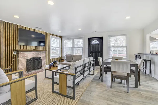 a living room with furniture a fireplace and a flat screen tv