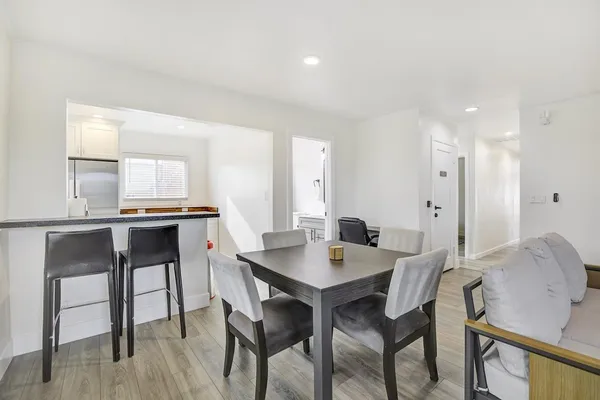 a view of a dining room with furniture and wooden floor
