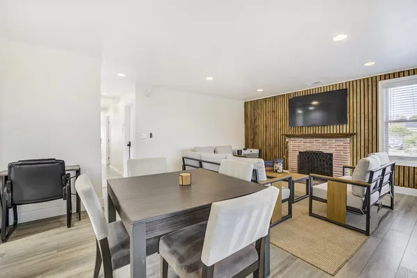 a living room with furniture a flat screen tv and a fireplace