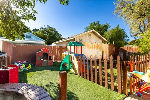 an outdoor sitting space with wooden fence