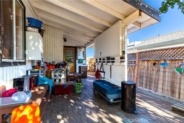 a view of a patio with table and chairs and potted plants