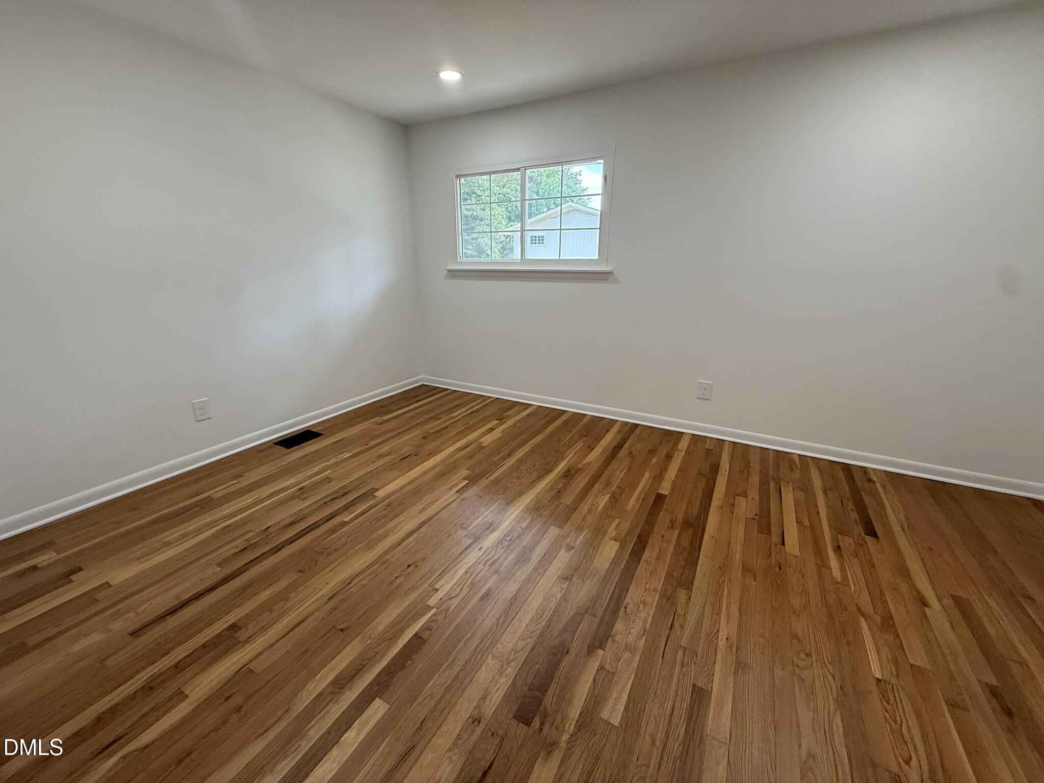 708 Hawes Court, Unit C Raleigh, NC 27608 - Photo 18 of 22 a view of empty room with wooden floor