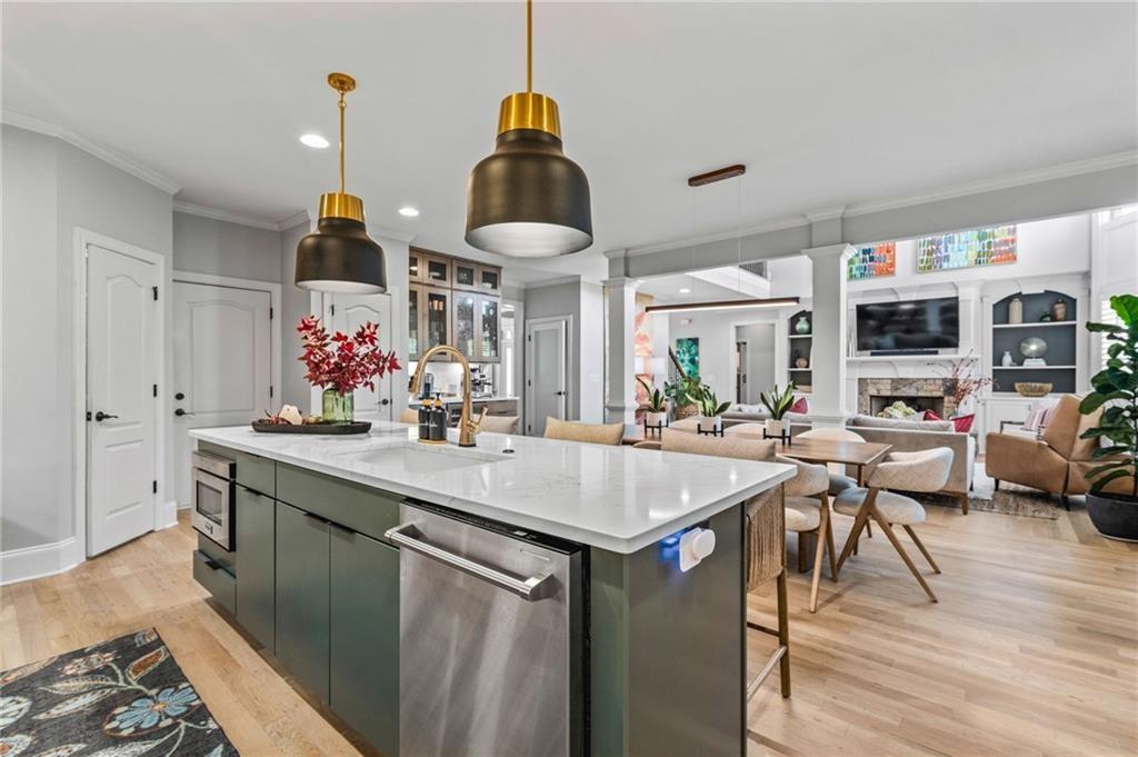 4526 Meadowland Way Flowery Branch, GA 30542 - Photo 11 of 64 a kitchen with stainless steel appliances granite countertop a sink stove and wooden floor
