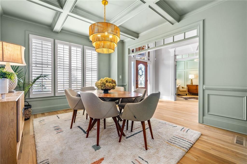 4526 Meadowland Way Flowery Branch, GA 30542 - Photo 13 of 64 a view of a dining room with furniture wooden floor and chandelier