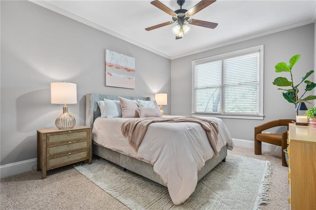 4526 Meadowland Way Flowery Branch, GA 30542 - Photo 21 of 64 a spacious bedroom with a bed a couch and potted plant on the dresser