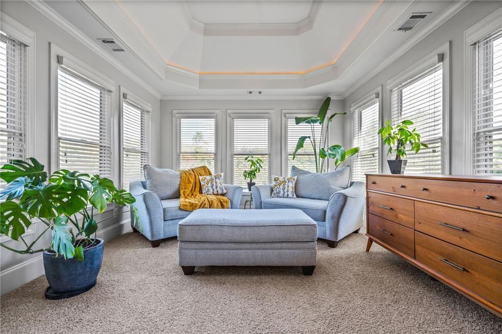 4526 Meadowland Way Flowery Branch, GA 30542 - Photo 25 of 64 a living room with furniture and a potted plant