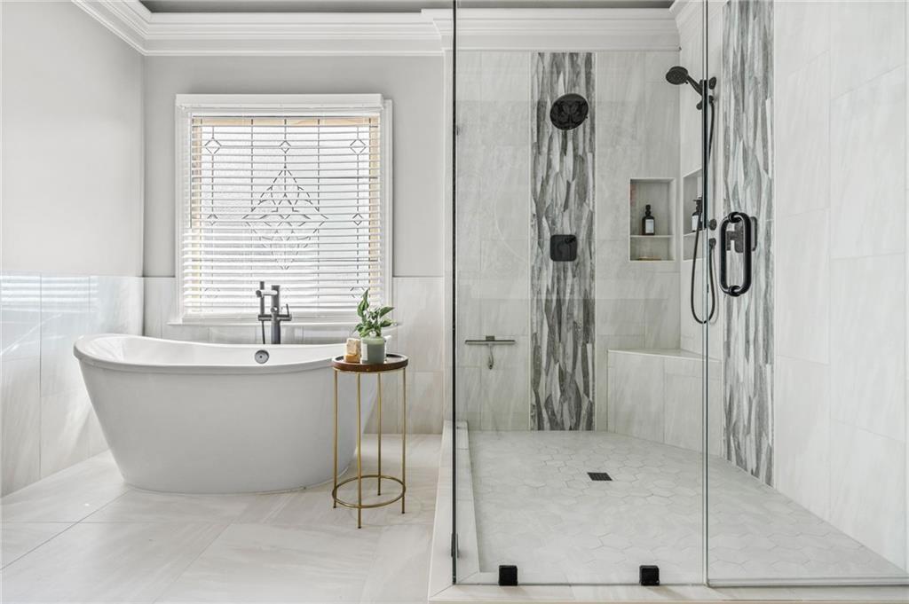 4526 Meadowland Way Flowery Branch, GA 30542 - Photo 29 of 64 a bathroom with a tub and shower