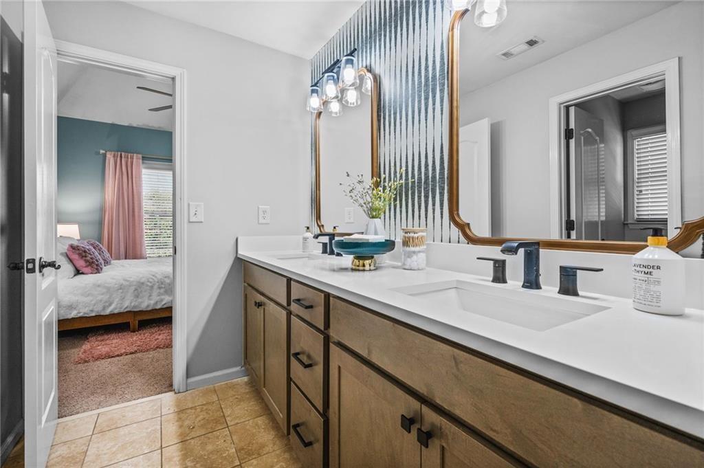 4526 Meadowland Way Flowery Branch, GA 30542 - Photo 36 of 64 a en suite bathroom with a double vanity sink and a mirror