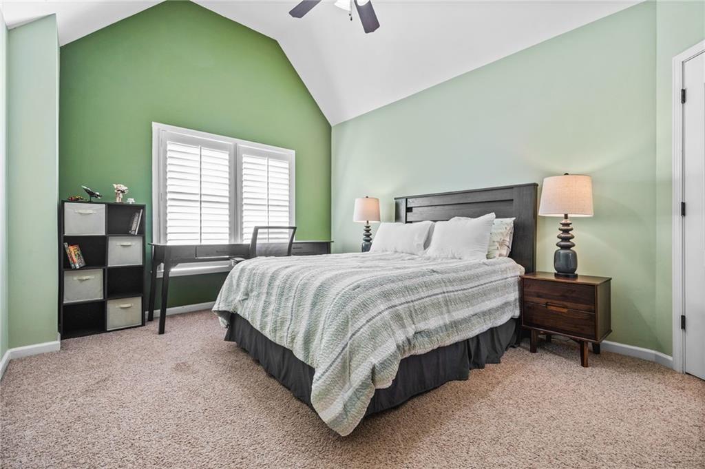 4526 Meadowland Way Flowery Branch, GA 30542 - Photo 37 of 64 a bed sitting in a bedroom next to a window