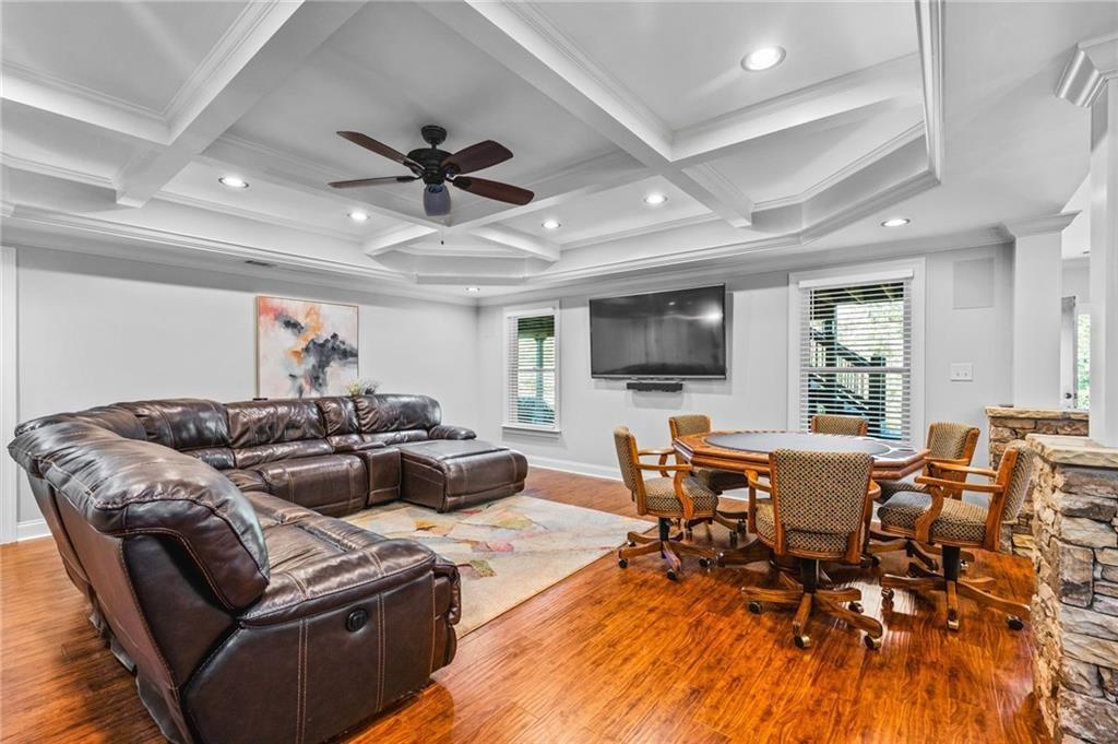 4526 Meadowland Way Flowery Branch, GA 30542 - Photo 39 of 64 a living room with furniture kitchen view and a flat screen tv