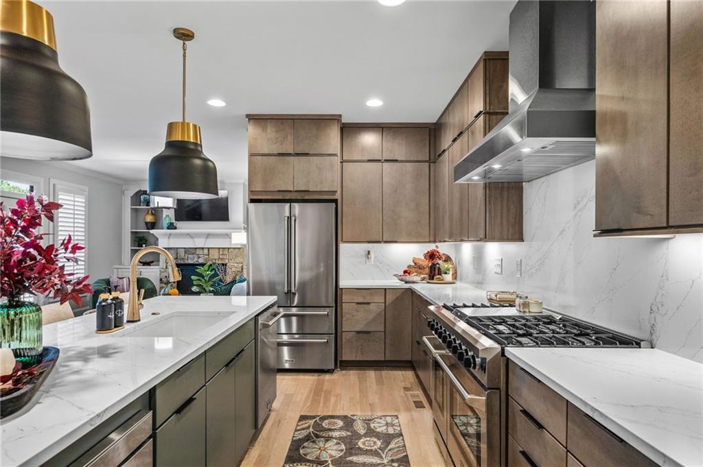 4526 Meadowland Way Flowery Branch, GA 30542 - Photo 9 of 64 a kitchen with stainless steel appliances granite countertop a sink stove and refrigerator