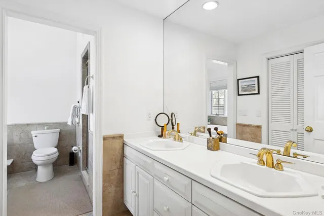 a bathroom with a sink toilet and a mirror