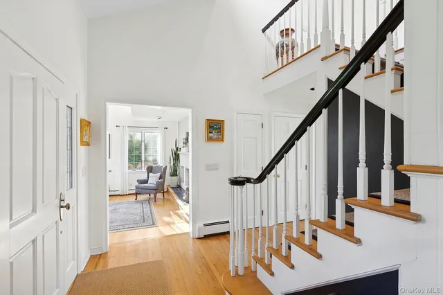 a view of an entryway with wooden floor and stairs