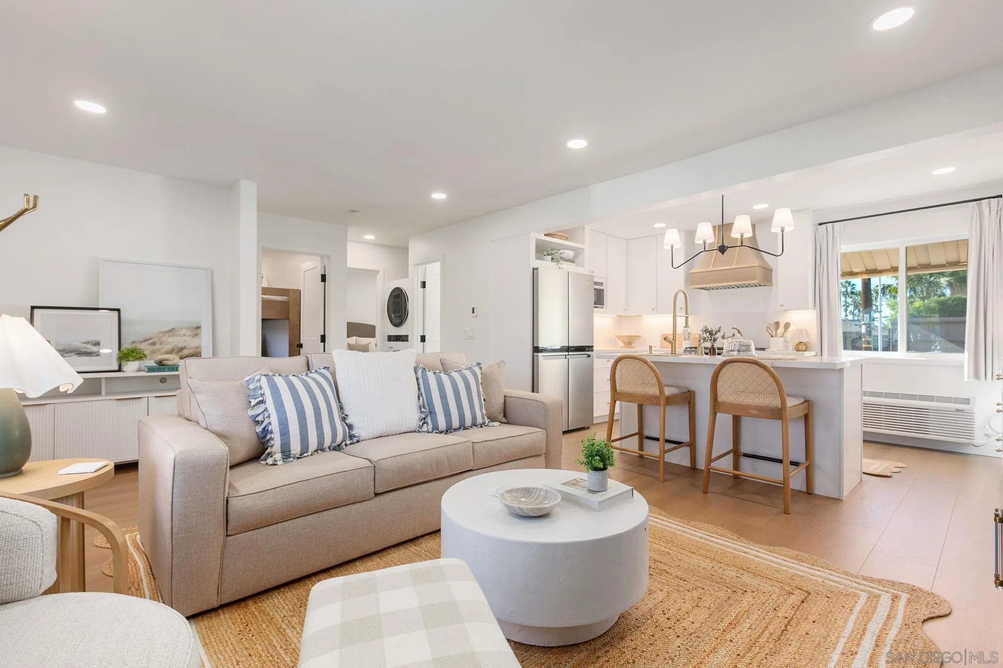 a living room with furniture and a dining table with wooden floor