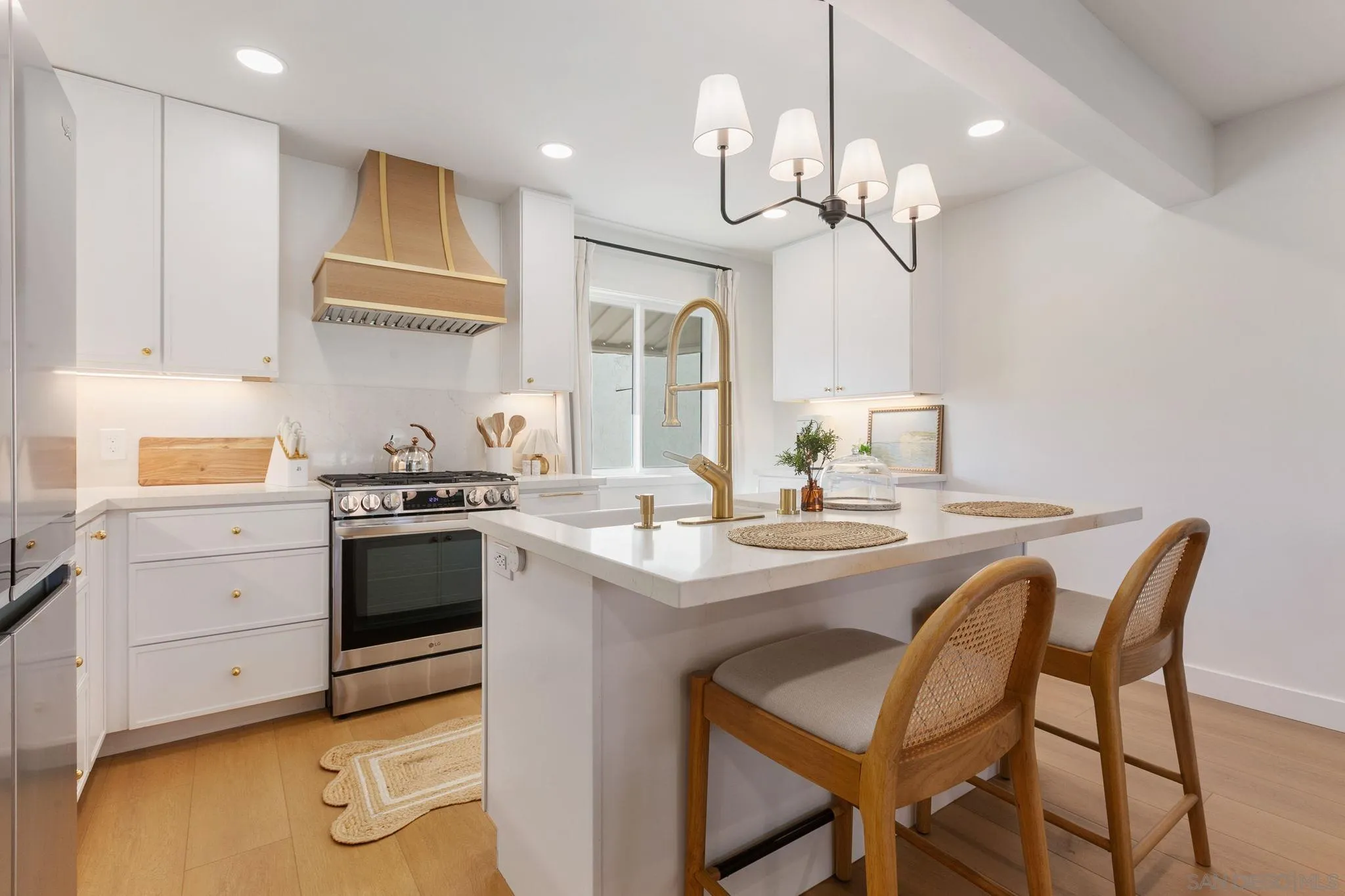 210 A Street, Unit 2 Encinitas, CA 92024 - Photo 8 of 44 a kitchen with a table chairs stove and cabinets