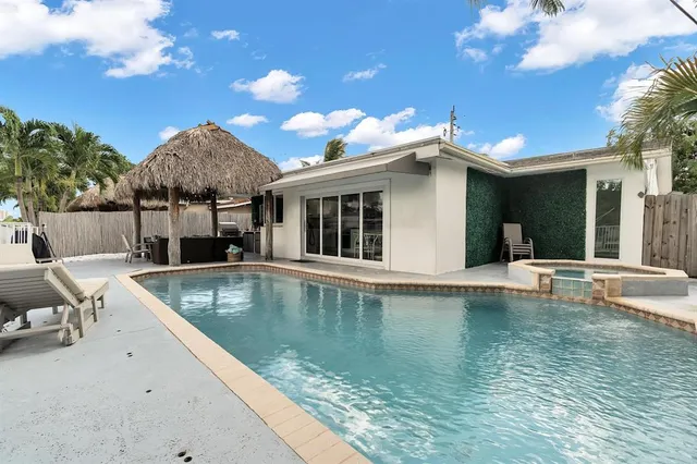 a view of a patio with couches chairs and potted plants with sky view