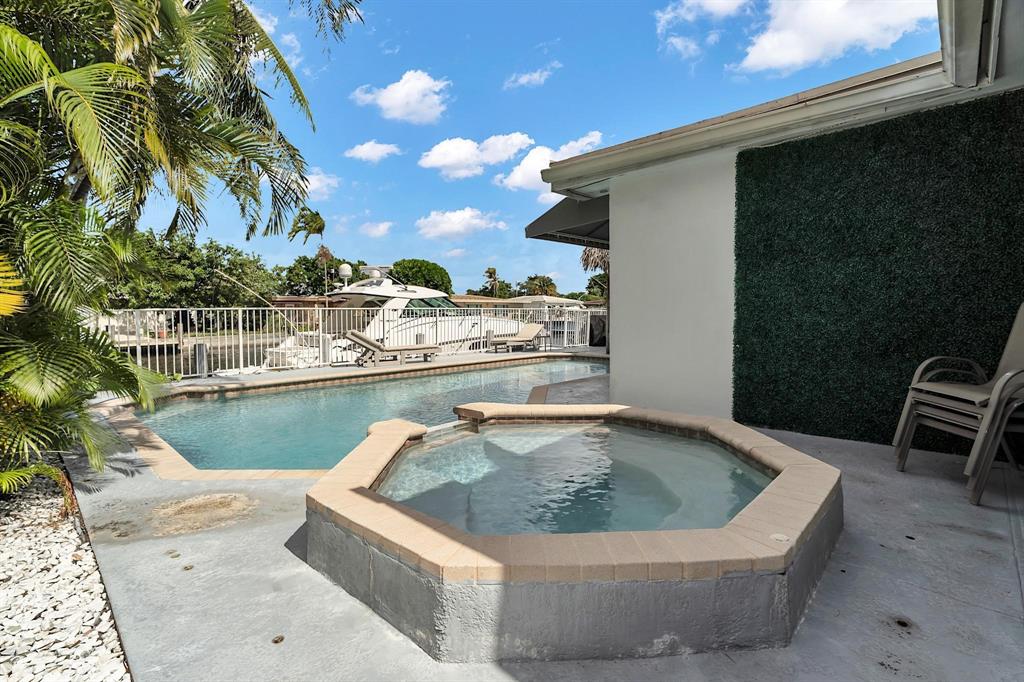2233 Southeast 15th Street Pompano Beach, FL 33062 - Photo 11 of 53 a view of a swimming pool with a lounge chair