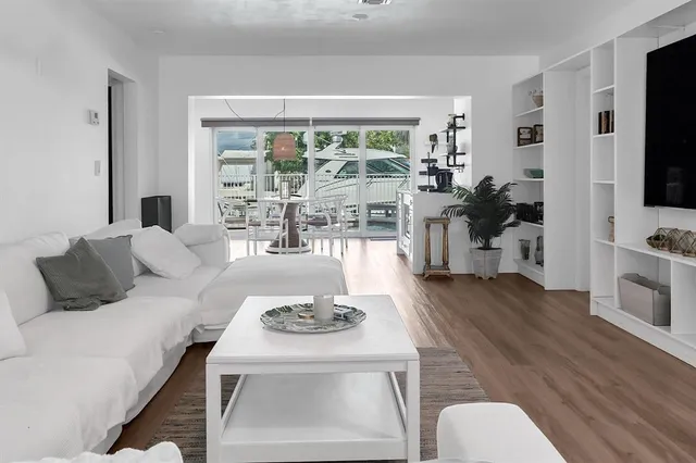 a living room with furniture large window and flat screen tv