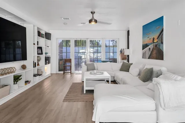 a kitchen with stainless steel appliances kitchen island granite countertop a dining table chairs and a oven