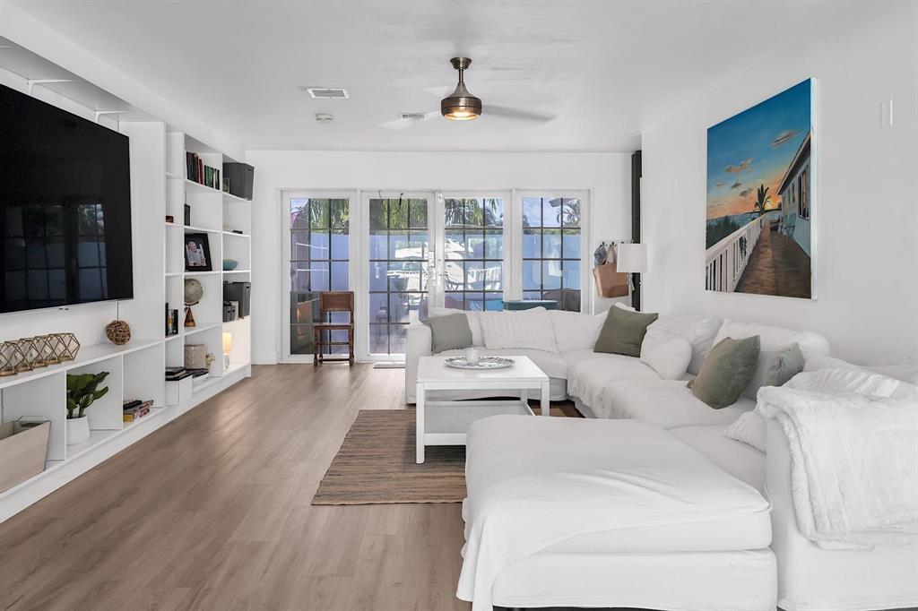 2233 Southeast 15th Street Pompano Beach, FL 33062 - Photo 20 of 53 a living room with furniture large window and flat screen tv