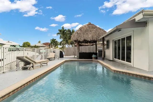 a view of a house with backyard porch and sitting area
