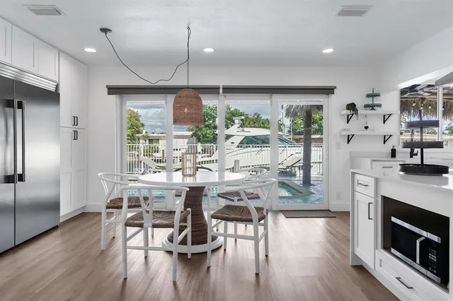 a kitchen with stainless steel appliances granite countertop a sink stove and white cabinets